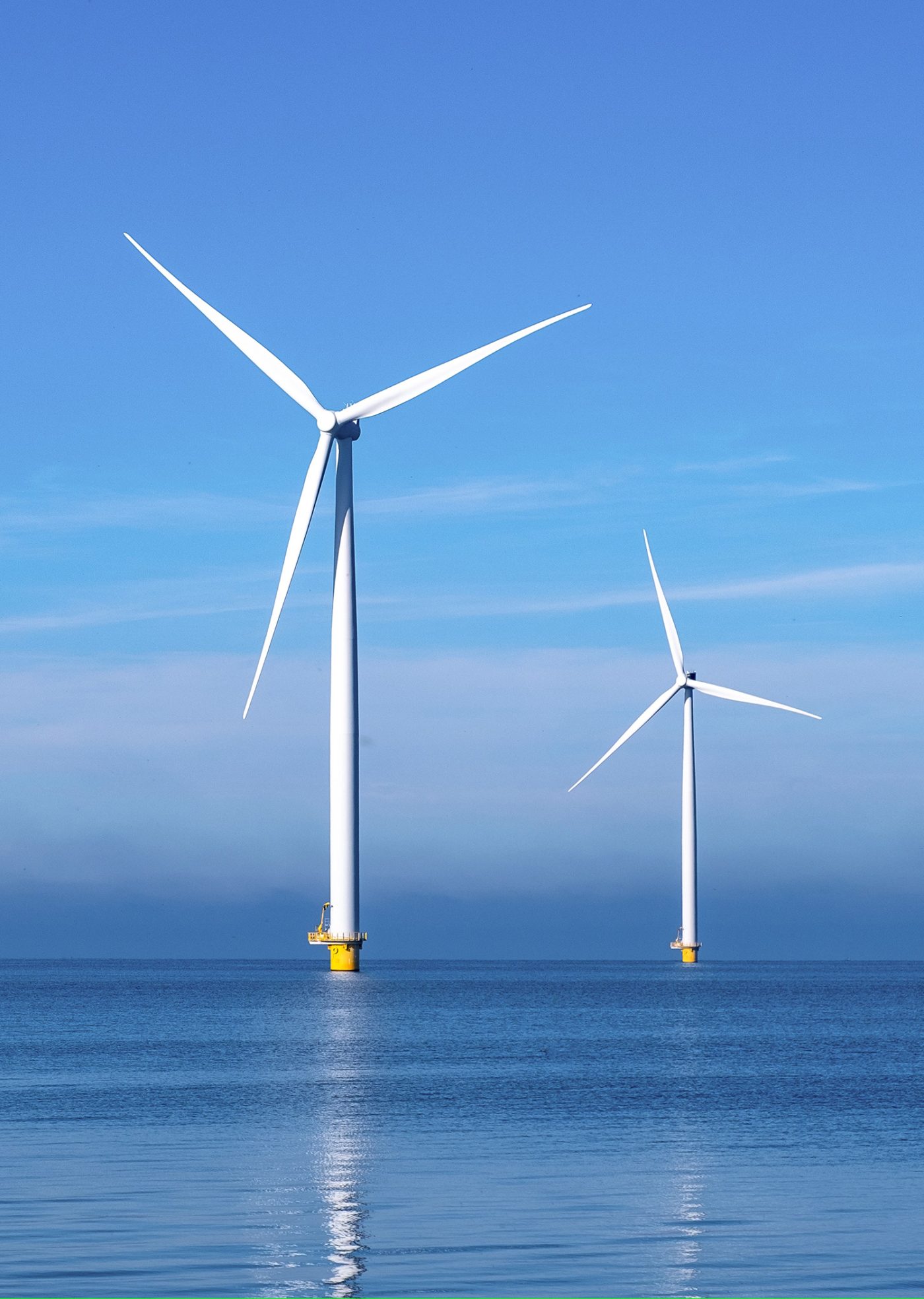 Windmill park with clouds and a blue sky, wind mill turbines in the ocean aerial view of a wind farm in the Nehterlands production clean energy